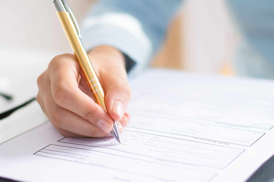 Closeup of business woman making notes in document Closeup of business woman making notes in document. Entrepreneur sitting at desk and writing. Paperwork concept. Cropped view.