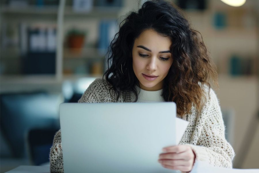 professional woman is sitting with a laptop